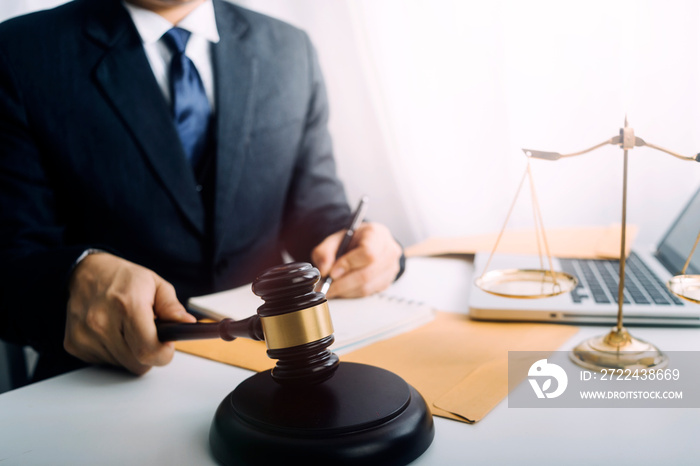 Business and lawyers discussing contract papers with brass scale on desk in office. Law, legal services, advice, justice and law concept picture with film grain effect