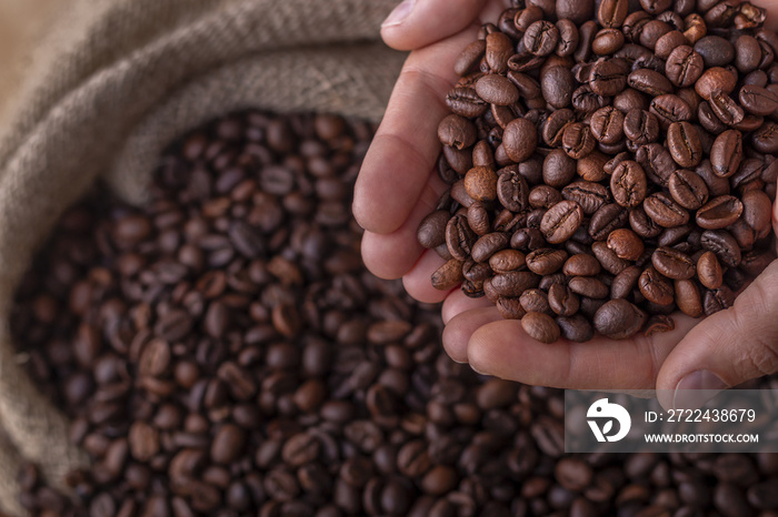 Hands on a sack of coffee beans