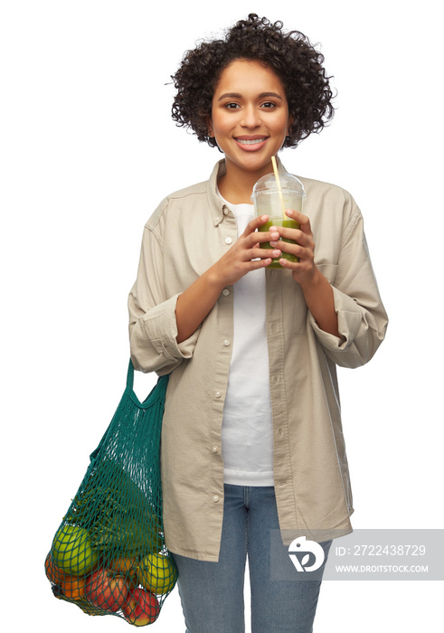 eco living, zero waste and sustainability concept - portrait of happy smiling young woman with reusable string bag drinking green takeaway smoothie or shake over white background