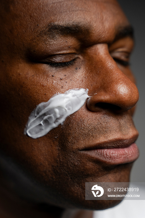 Close-up of man with face cream