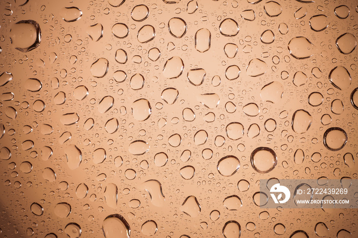 water drops on Brown glass background.