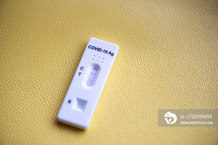 Rapid antigen detection test (RADT) with COVID-19 Ag inscription and one red stripe showing a NEGATIVE