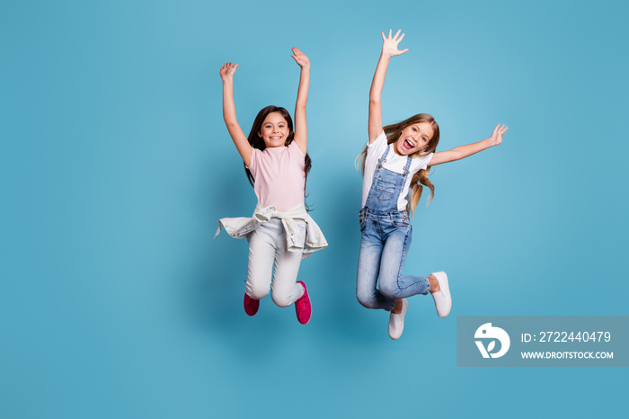 Full length body size view of two people attractive charming cheerful careless carefree straight-haired pre-teen girls having fun party overjoy great weekend day isolated on blue pastel background