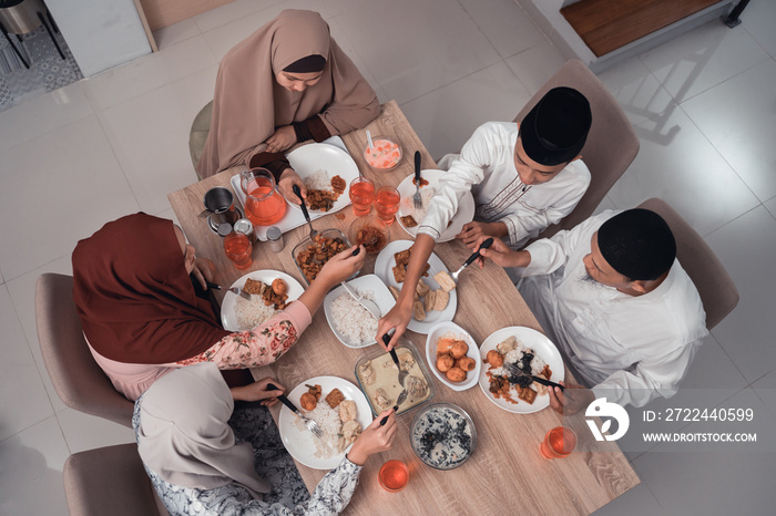 top view asian muslim family iftar dinner together at home. break fasting concept