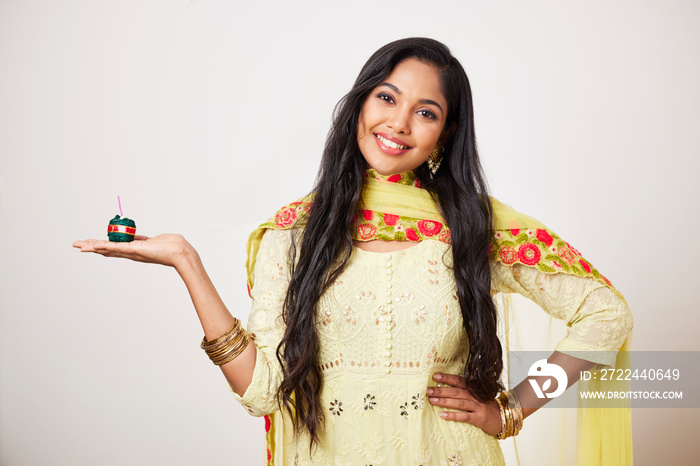 Indian pretty young woman celebrating Diwali festival with fire crackers.