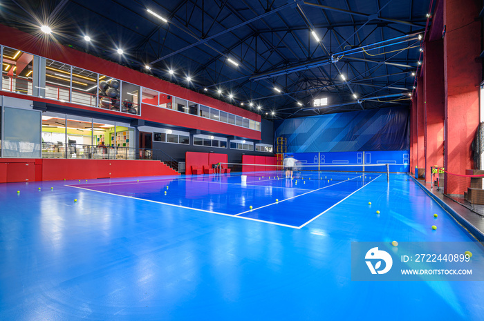 Blue colored empty indoor tennis court