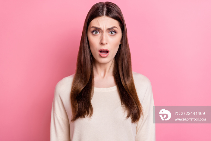 Portrait of attractive worried desperate brown haired girl bad news reaction isolated over pink pastel color background