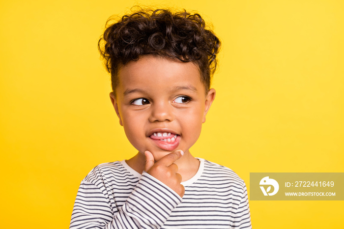 Photo portrait cheerful small boy looking copyspace in striped shirt isolated bright yellow color background