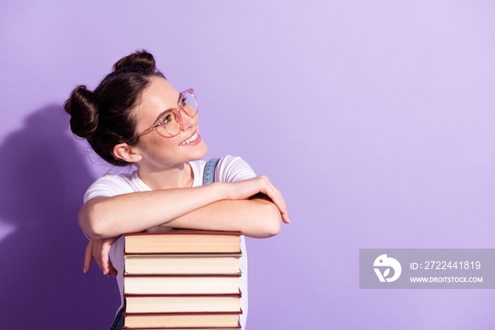 Photo of young girl happy positive smile look empty space books isolated over violet color background