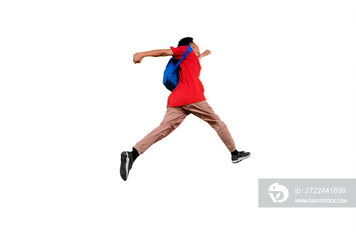 Male student running with his backpack in studio