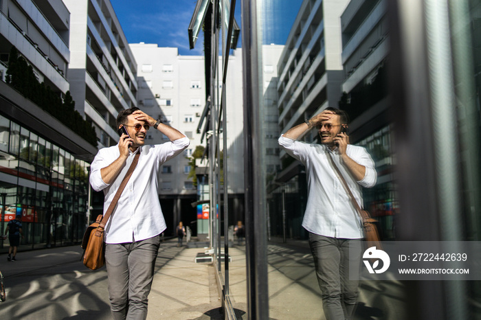 Business man walking down the street and talking on phone