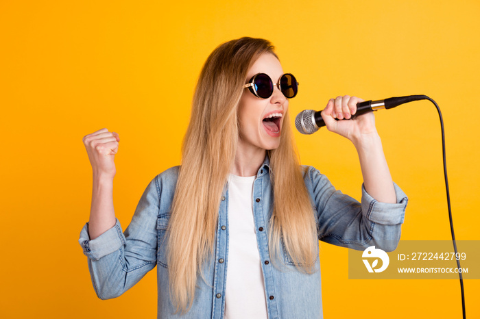 Photo of female pop star singing song on stage festival isolated on bright yellow color background