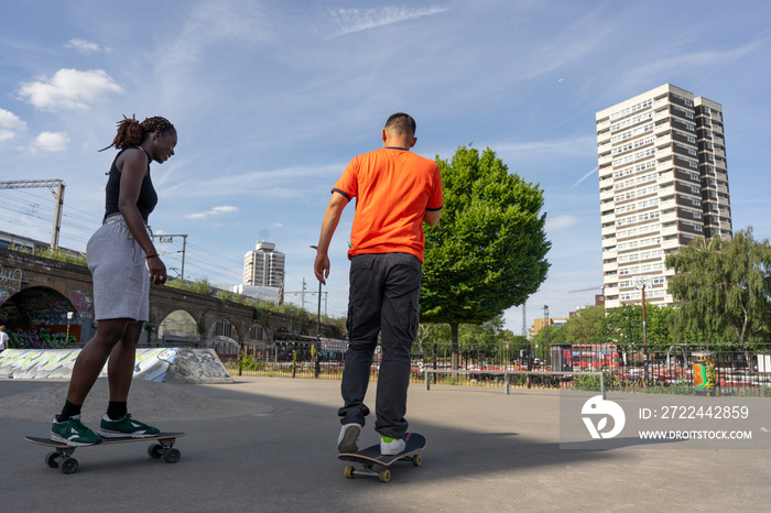 Young people skateboarding in skate park