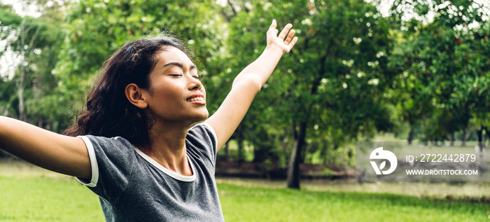 Asia woman standing stretch her arms relax and enjoy with nature fresh air