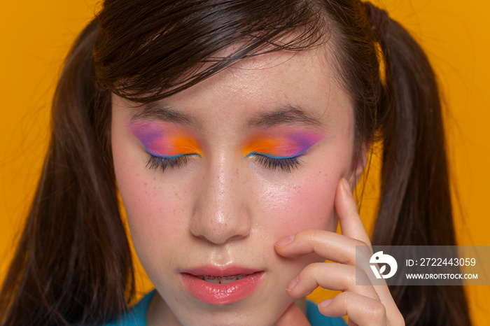 Studio portrait of girl with colorful make-up