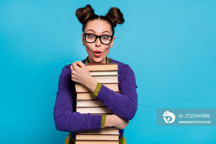 Close-up portrait of her she nice attractive pretty genius brainy amazed cheerful girl embracing pile book knowledge isolated on bright vivid shine vibrant blue green teal turquoise color background