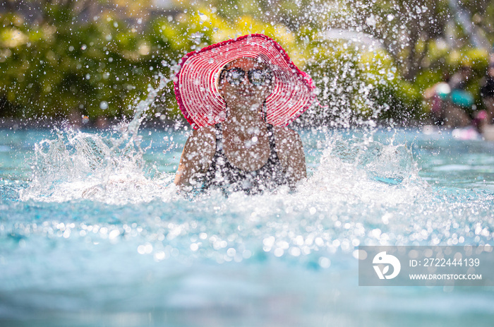 Woman playing in swimming pool