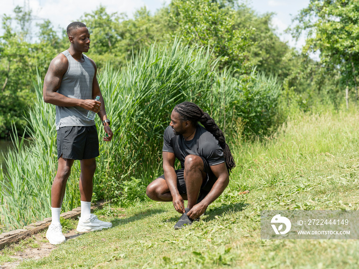 Two men exercising together in park