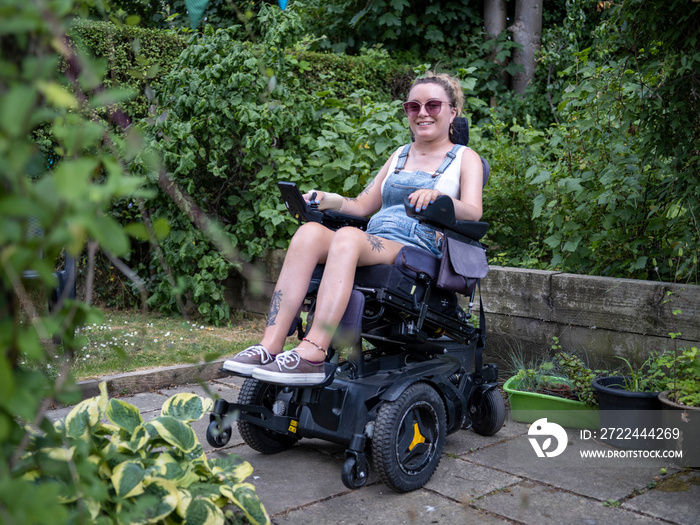 Woman in electric wheelchair in back yard