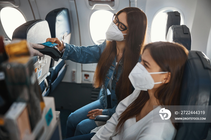 Female buying food from airplane trolley with credit card