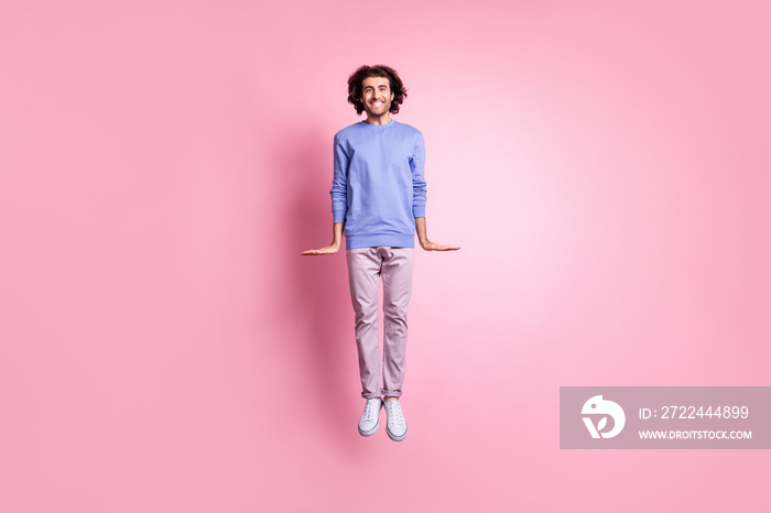 Full size photo of young attractive smiling cheerful positive man fly jump wear purple trousers isolated on pink color background