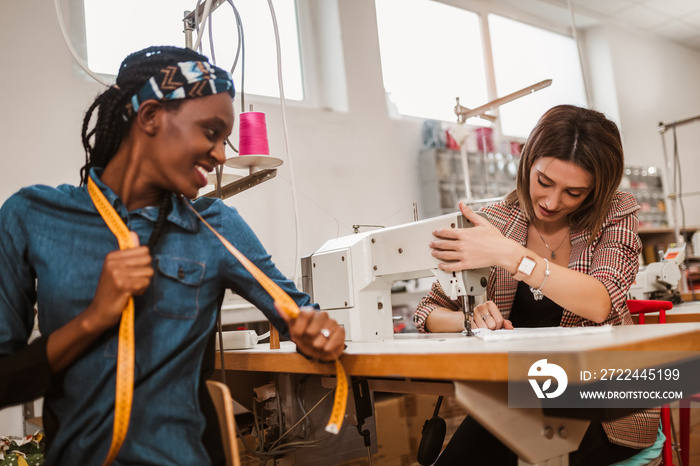 Dressmaker woman working with sewing machine