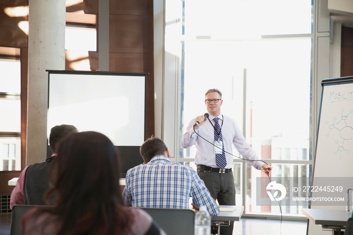 Speaker using microphone at conference presentation