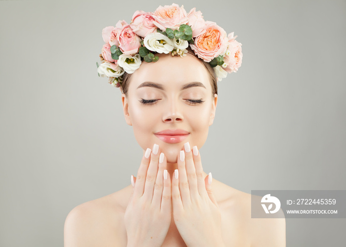 Portrait of perfect woman spa model with clear skin, manicured nails and flowers