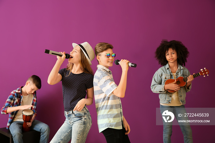 Teenage musicians playing against color background