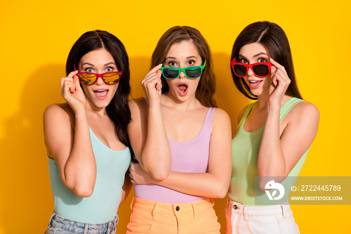 Photo of young beautiful smiling excited amazed girl in sunglass look impressed isolated on yellow color background