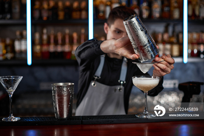 professional bartender makes cocktail in a nightclub.