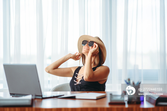 Businesswoman dreaming about a vacation in office