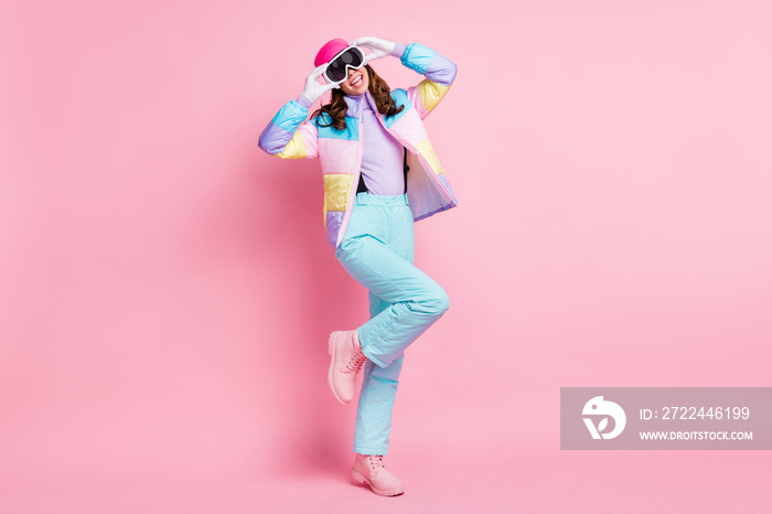 Full length photo of sweet adorable lady snowboarder wear colorful coat arms eyewear isolated pink color background