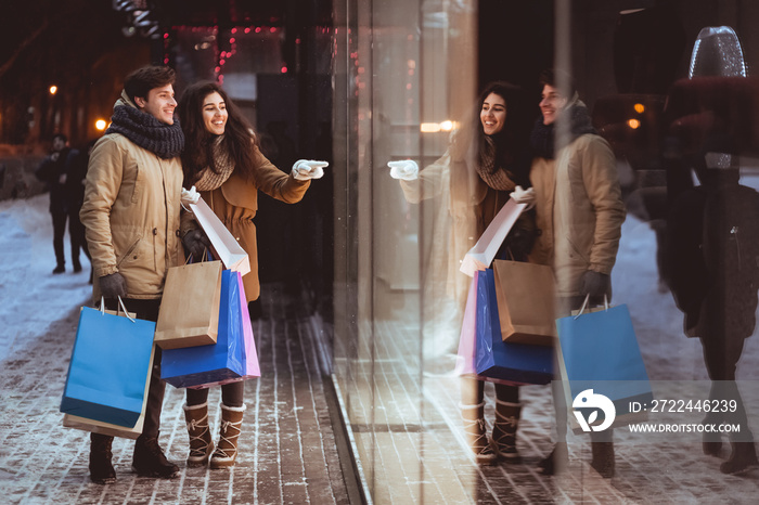 Girl Pointing At Shopwindow Shopping With Boyfriend In Night City