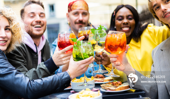 Happy young people toasting with colored cocktails in the city centre - Multiracial friends having fun together while enjoying spring - Friendship and summertime concept.