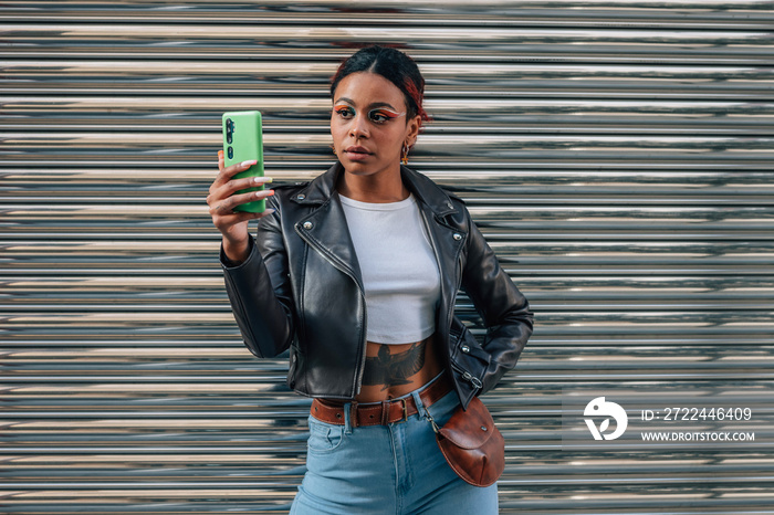 girl with mobile phone in the street, half body