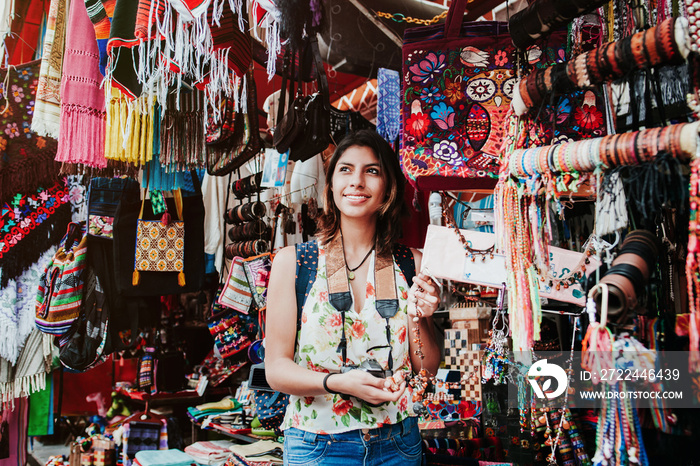 Latin woman backpacker shopping in a Tourist Market in Mexico City, Mexican Traveler in America