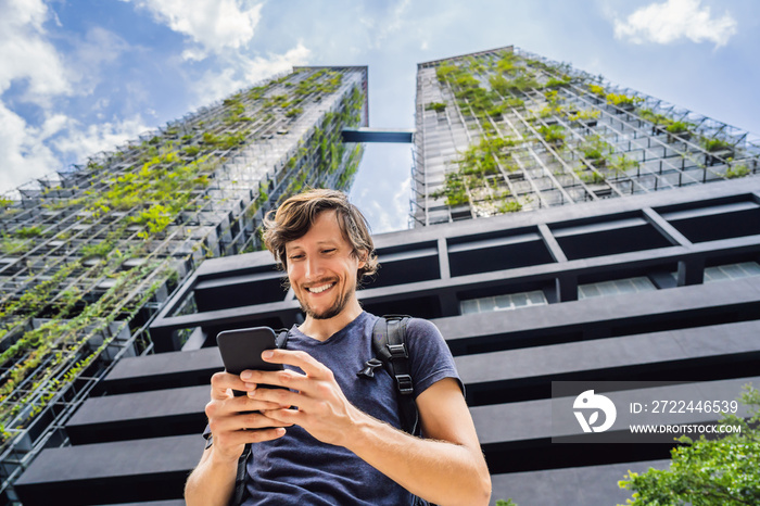 man using map app on smartphone on the background of skyscrapers