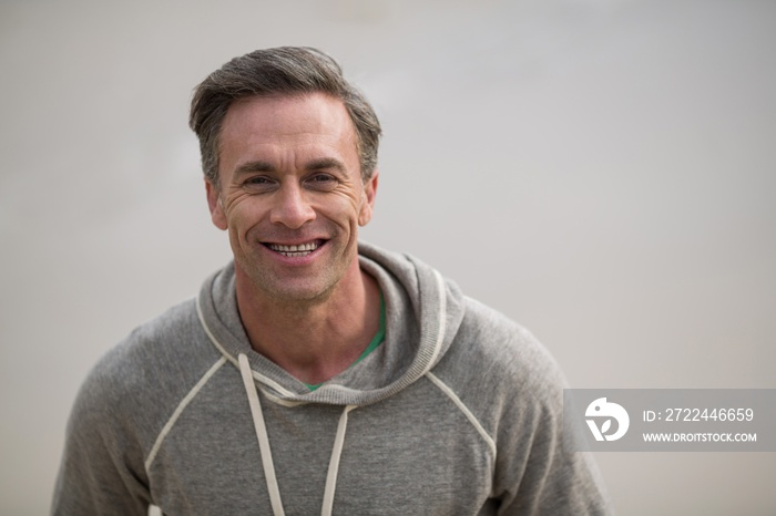 Smiling mature man standing on the beach