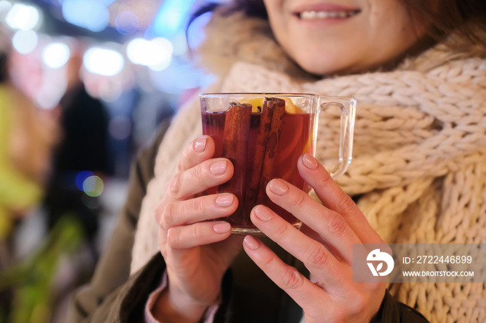 Close-up mug with mulled wine in woman hands