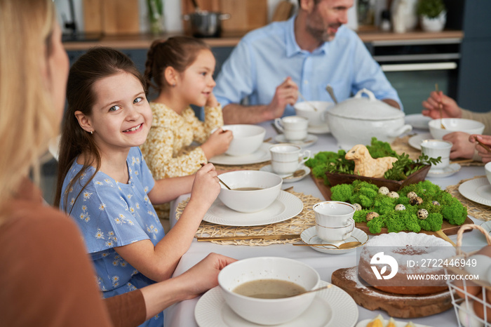 Caucasian family of five eating an easter dinner at home