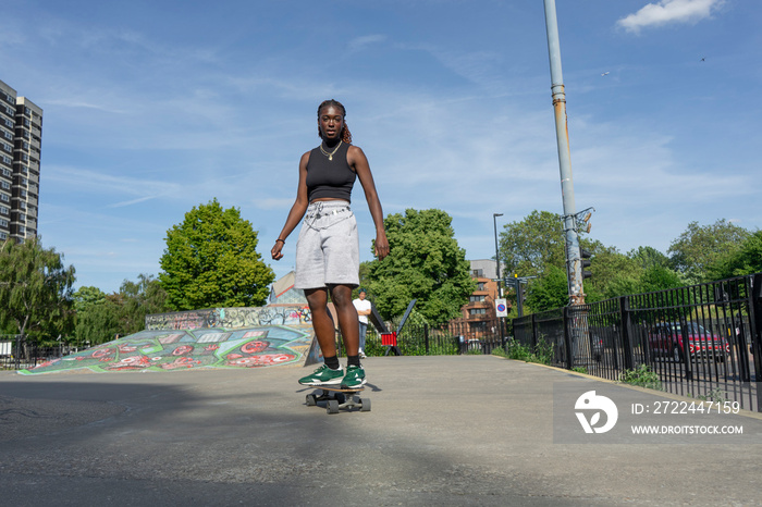 Young woman skateboarding in skate park