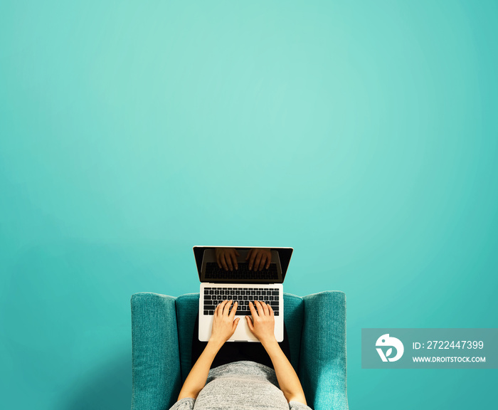 Woman using a laptop computer overhead view