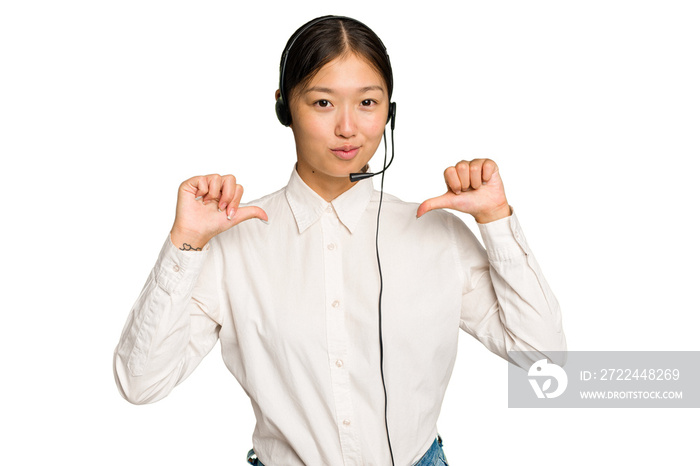 Telemarketer asian woman working with a headset isolated on green chroma background feels proud and self confident, example to follow.