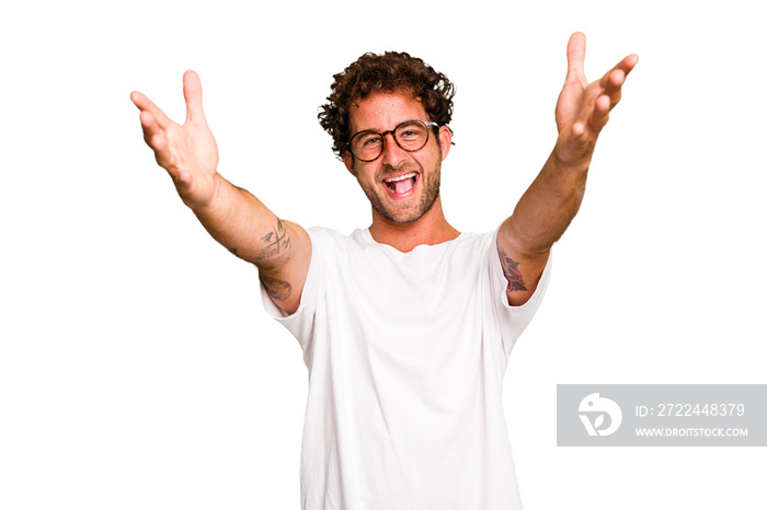 Young caucasian curly hair man isolated Young caucasian man with curly hair isolated feels confident giving a hug to the camera.