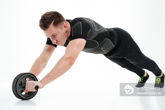 Full length portrait of a healthy athlete man doing exercises