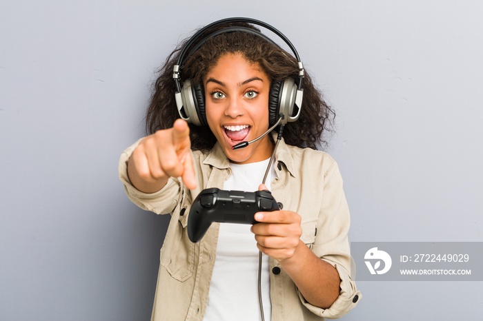 Young african american woman using headphones and game controller