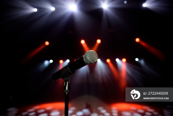 Close-up of microphone at concert against blur colorful light background