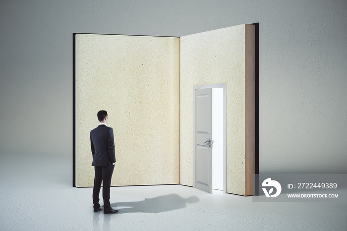 Bsinessman looking at abstract open book with door on white background.