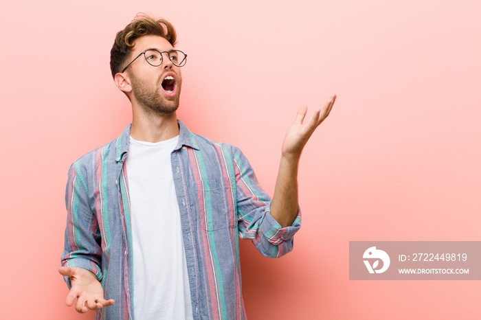 young man performing opera or singing at a concert or show, feeling romantic, artistic and passionate against pink background